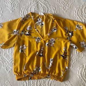 Cute yellow floral shirt with a v neck.